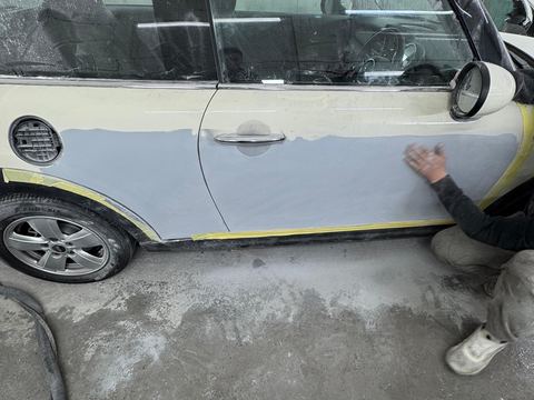 Mini Cooper door in primer and masked for paint